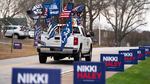 A supporter of former President Donald Trump drives past campaign signs for Republican presidential candidate Nikki Haley in Irmo, South Carolina. The state's Republican presidential primary is on Feb. 24.
