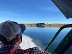 Think Out Loud host Dave Miller looks out over the Hanford Nuclear Reservation from a boat on the Columbia River in the Hanford Reach National Monument.