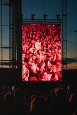 A member of the audience holds up a heart-shaped sign reading "Dear Joni the world loves you" during "Joni Jam" at the Gorge Amphitheatre.
