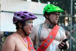Volunteers of the World Naked Bike Ride promote bike safety and the recommended dress code by wearing helmets. Portland Police Bureau said wearing helmets and shoes should be the "bare minimum" in a statement released prior to the event. 