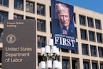 A portrait of President Donald Trump hangs on the Labor Department headquarters in Washington, D.C. on Aug. 25, 2025. The agency is bringing back some workers who took the government’s deferred resignation offer. Still other employees whose jobs were eliminated received notices that they would be assigned to new positions.