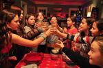 Left to right, Maeve Larco, Matisse Nash, Ruby Cooper-Karl, McKenzie Caldicott, Maya Rashid, Brooke Abbruzzese, Willa Gagnon and Lily Buckenmeyer toast with apple cider after kitchen-testing Jenn Louis's kale salad in December 2014.  