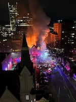 Smoke rises from the former Portland Korean Church on Tuesday night after firefighters doused the flames.