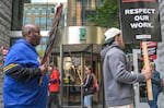 Workers at Hilton’s Embassy Suites in Seattle’s Pioneer Square neighborhood went on strike in June. Some could be affected by a rule change concerning striking workers who seek unemployment benefits.