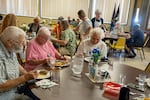 People enjoy a free community meal at James 2 Community Kitchen, a free weekly community meal hosted at Dallas United Methodist Church in Dallas, Ore., on Aug 1, 2026.