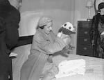 Ruth Harkness holds Su Lin at her hotel room in New York City.  