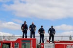 Firefighters watch the funeral procession for Cowlitz County Sheriff's Deputy Justin DeRosier from a Vancouver, Washington, overpass on April 24, 2019. DeRosier was shot and killed on April 13, 2019, while responding to a complaint.