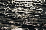 The sunset reflects on ocean waves seen from Jan Cortsen's boat in Ilulissat, Greenland on Feb. 18, 2025.