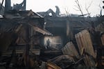 Firefighters work to extinguish a fire at a house after a Russian attack in Kharkiv, Ukraine, Monday, April 11, 2022.