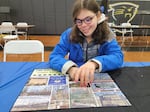 Mora Leeb places some pieces into a puzzle during a local puzzle tournament. The 15-year-old has grown up without the left side of her brain after it was removed when she was very young.