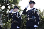 Law enforcement officers salute as the memorial procession for slain Seaside Police Sgt. Jason Goodding passes.