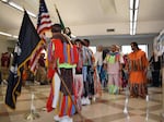 Dancers make their grand entry into a meeting room at the start of a powwow in late October at the Airway Heights Corrections Center, near Spokane, Wash.