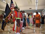 Dancers make their grand entry into a meeting room at the start of a powwow in late October at the Airway Heights Corrections Center, near Spokane, Wash.