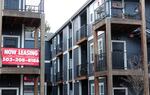 FILE - A 'Now Leasing' sign hangs off an apartment building staircase in southeast Portland, Ore., on Wednesday, Dec. 9, 2021.