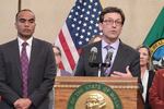 Washington Gov. Bob Ferguson speaks at a press conference Thursday, Feb. 13, 2025. He was accompanied by Attorney General Nick Brown (left). 