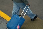 A traveler arrives at International Airport in Portland, Ore., on Thursday, Nov. 13, 2025.