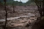 Rescue workers search for victims in Bento Rodrigues, Brazil, two days after a tsunami of mud, caused by a dam break, engulfed the town in the state of Minas Gerais, Nov. 8, 2015.