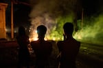 People look at a barricade set up by residents protesting against prolonged power outages in Havana, Cuba, Wednesday.