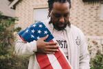 Edmund Garcia, an Iraq war veteran, holds the American flag over his shoulder outside his home on Thursday in Rosharon, Texas.