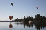 Hot air balloons reflect off the lake at Big Summit Prairie in Central Oregon.