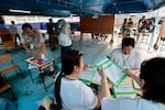 Police officers and election volunteers prepare for the general election at a voting station in Bangkok, on Sunday, Feb. 8, 2026. (AP Photo/Wason Wanichakorn)