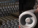 Ammunition casings are stacked on top of each other in a storage space; A Scranton Army Ammunition Plant employee performs inspections on metal billets during the manufacturing process