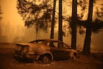 FILE - A burned out car in Gates, Ore., following devastating statewide fires in September 2020.