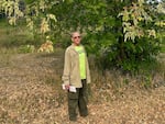 Richard Sniezko stands under an Oregon ash tree in Dorena. Yellow-brown seed pods, or samaras, hang from the tree around him.