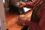 Jordan Heinz pours a latte at the Jolts and Juice Coffee Company.