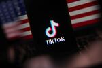 The TikTok logo is screened on a mobile phone with U.S. flag in the background for illustration photo in Krakow, Poland, on Jan. 17.