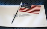 An information packet and an American flag are placed on a chair at the U.S. Citizenship and Immigration Services Miami Field Office on Aug. 17, 2018, in Miami.