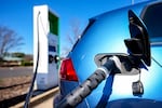 A vehicle is plugged into a Electrify America electric vehicle charger, Friday, Feb. 2, 2024, in Kennesaw, Ga., near Atlanta.
