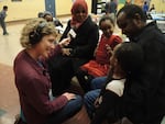Amanda Peacher interviews first grader Munira and her family during parent/teacher conferences at Earl Boyles Elementary.