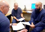 Jordan Gamroth (left), Sam Hannah (center) and Jordan Tippet (right) discuss a research article in their health class at Deer Ridge Correctional Institution on April 29, 2024.