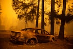 The charred husk of a car in a neighborhood burned in the Santiam Fire near Gates, Ore., Sept. 9, 2020. 