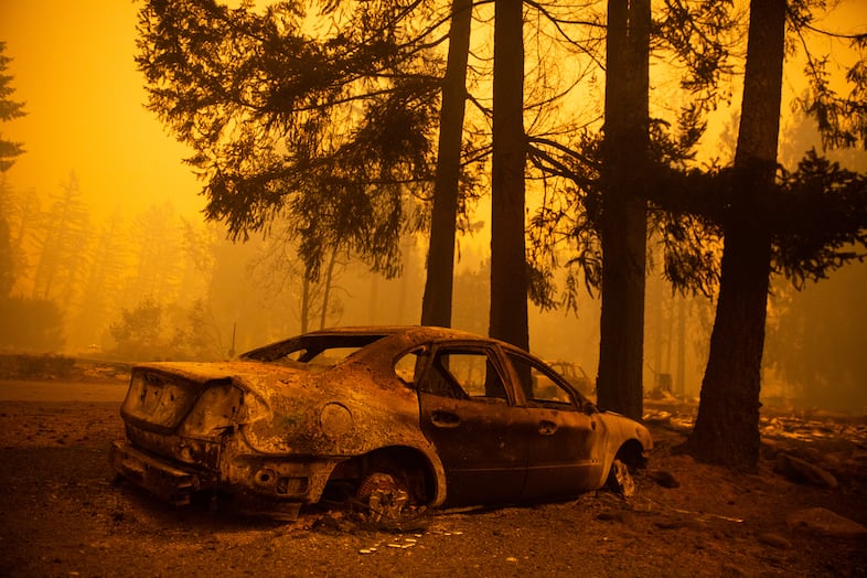 The charred husk of a car in a neighborhood burned in the Santiam Fire near Gates, Ore., Sept. 9, 2020.