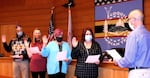 Four Coquille Tribal Council members take the oath of office.