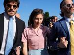 Amanda Knox arrives flanked by her husband Christopher Robinson, right, at the Florence courtroom in Florence, Italy, on Wednesday.