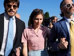 Amanda Knox arrives flanked by her husband Christopher Robinson, right, at the Florence courtroom in Florence, Italy, on Wednesday.