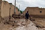 A man walks near his damaged home after heavy flooding in Baghlan province in northern Afghanistan on Saturday.
