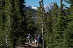 Hikers descend from Tam McArthur Rim outside Bend, Ore., Friday, Sept. 24, 2021.