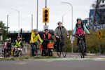 Commuters and Portland Bureau of Transportation volunteers ride on Southwest Naito Parkway in a special Wednesday bike bus from North and Northeast Portland, led by PBOT employee Sarah Goforth, right, set up for commuters impacted by the I-5 closure, in Portland, Ore., on Sept. 30, 2026.