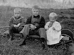 Three boys pose, most likely near Grants Pass, for Amos Voorhies, an entrepreneur and newspaperman whose style was very unique for his day. Voorhies featured everyday people in their natural surroundings.
 