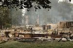 A structure on N. Westgate Pl. that burned in a wildfire is seen, Sunday, Aug. 2, 2026, in Spokane, Wash.