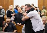 Jill Brown, wife of Clark County sheriff's Sgt. Jeremy Brown, shares an emotional moment with Sgt. Brown's son, Gage Brown, after the sentencing of Guillermo Raya Leon at the Clark County Courthouse in Vancouver, Wash., on Thursday morning, Oct. 5, 2023. Raya Leon was sentenced to life in prison after he was found guilty of aggravated first-degree murder in the 2021 fatal shooting of Sgt. Brown. 