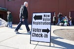 A sign for new voter registration is seen outside a polling location in Derry, N.H., on March 11.