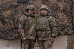 Friends Inna, 51, (left) with a callsign Cherry, and Valentyna, 51, with a callsign Valkyrie, pose for a portrait in Kyiv region, Ukraine on Nov. 9, 2024.