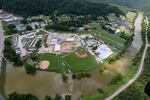 In this aerial image, the river is still high around the homes in Breathitt County, Ky., on Saturday.