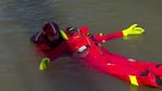 Seamanship students learn to jump over the side and float in the water wearing an immersion suit.
