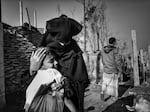 A mother and son are reunited the day after being separated during a fire in the camp.